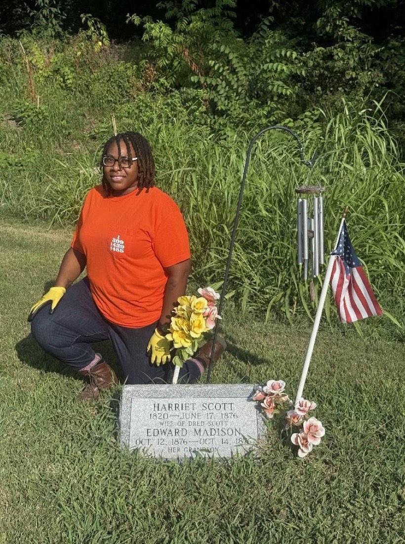 A member tends the grave of Harriet Scott